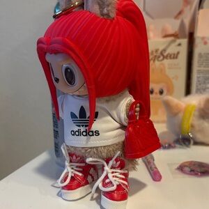 Red 3D printed hair with sports shirt and Red Hightops and red purse. No doll